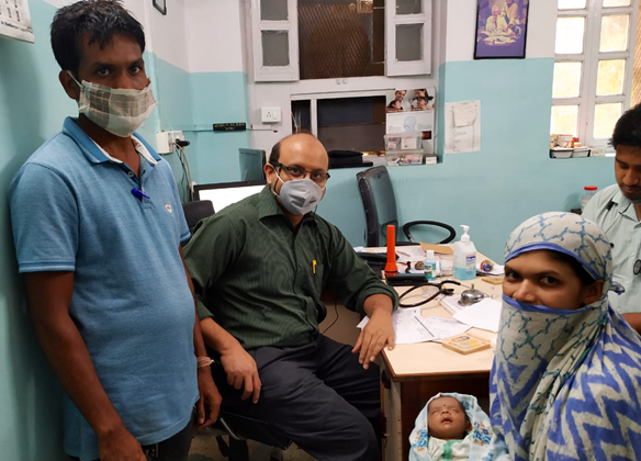 CCH staff pose with a healthy Ranjana and baby Samson