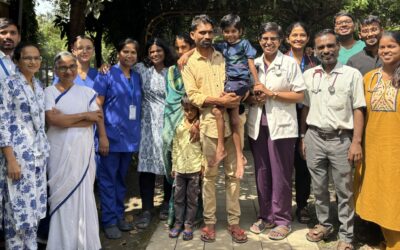 Piyush surrounded by family and the team that cared for him, including Dr Jibi John, front row, second from the right.